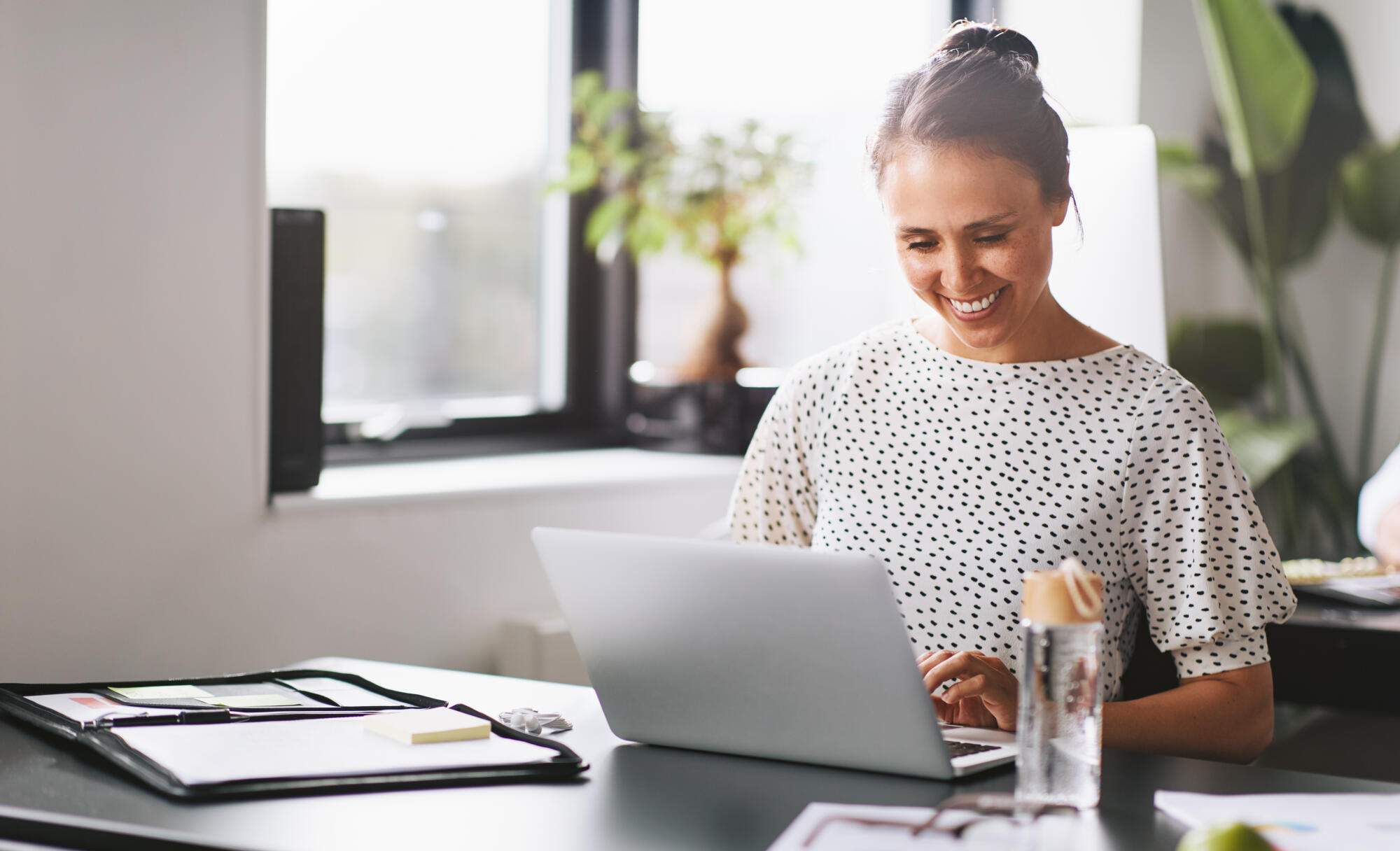 Smiling greying women on a computer researching the best payday loans online for medical bills.