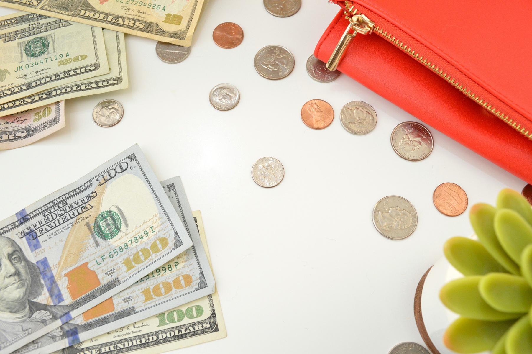 Money on the table next to a wallet